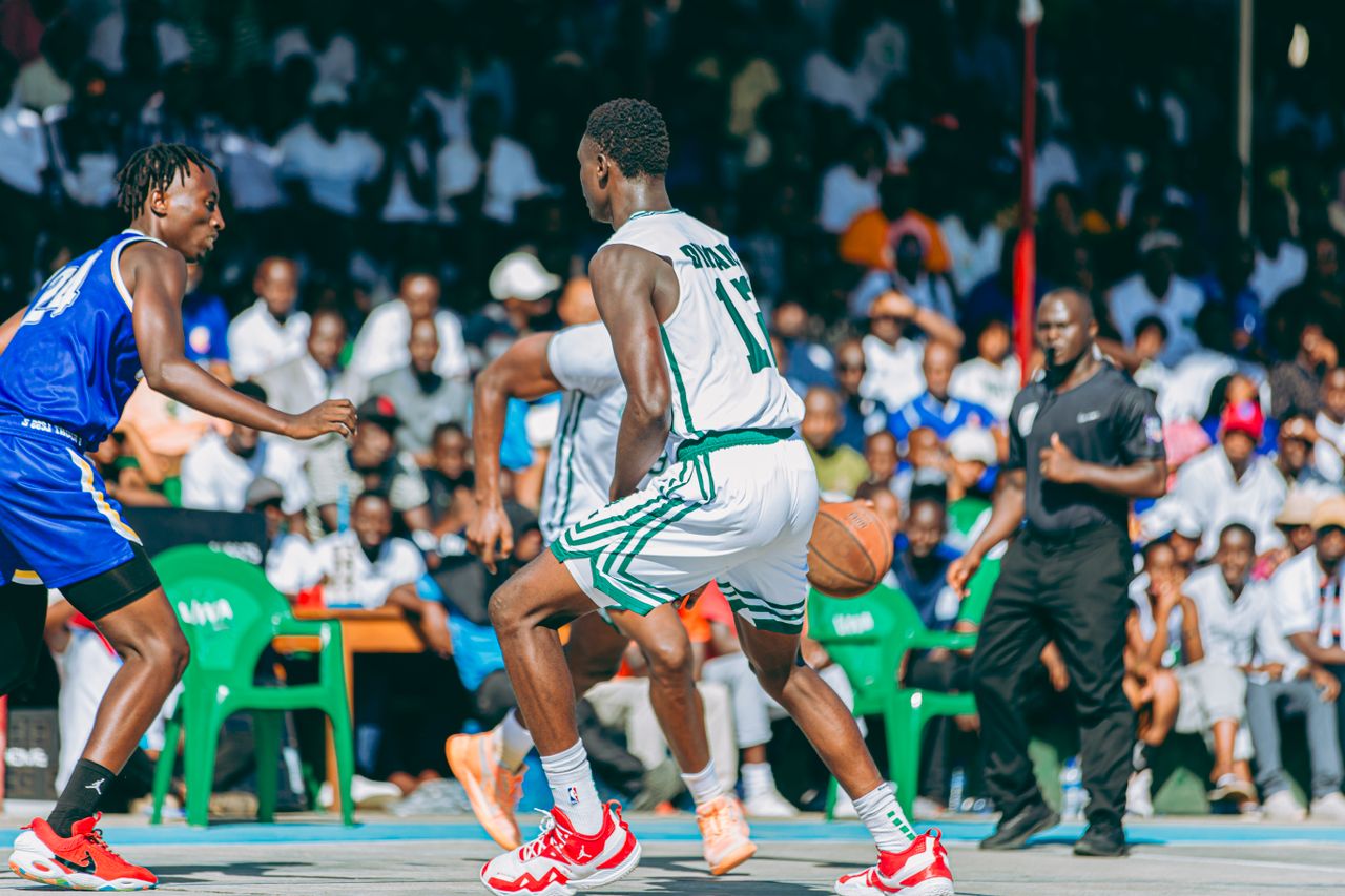 About Dynamic outdoor basketball game with players competing fiercely in front of an engaged crowd.