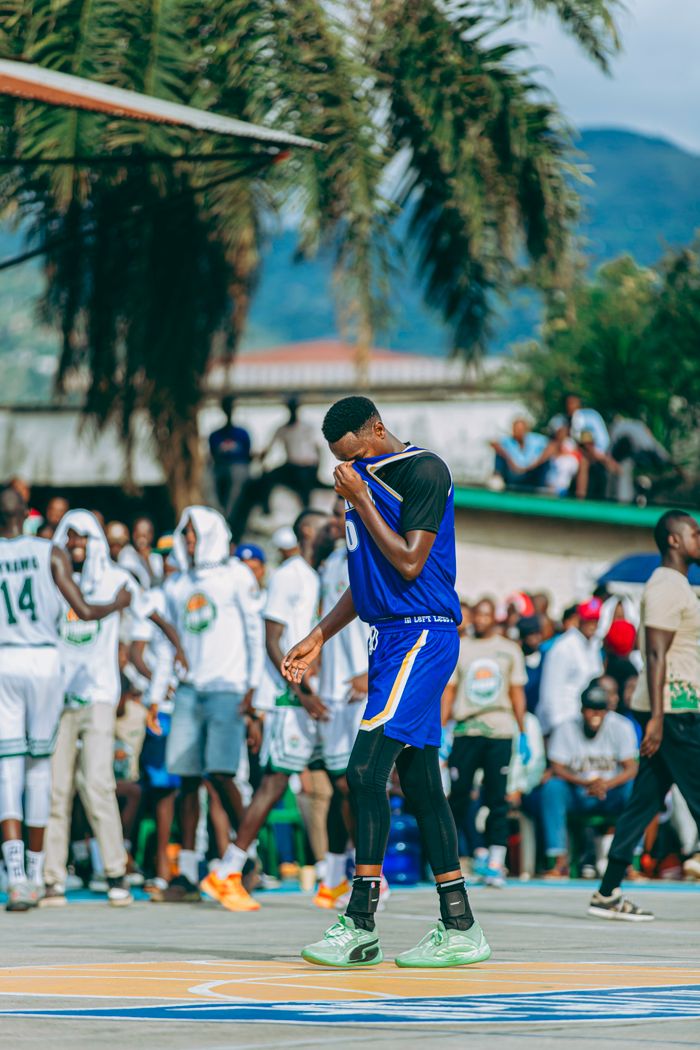 Services Vibrant outdoor basketball game with players and a cheering crowd.